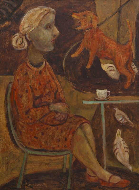 A seated woman at a table with a cat on her lap and a barking dog and 2 pigeons behind her.