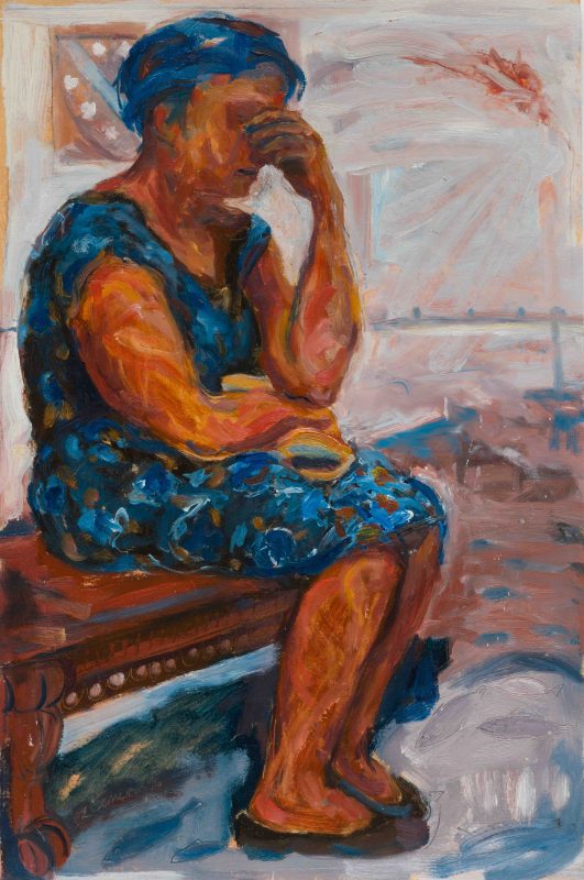 A seated woman prays