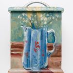 A small biscuit box . One side is painted with flowers in a jug .